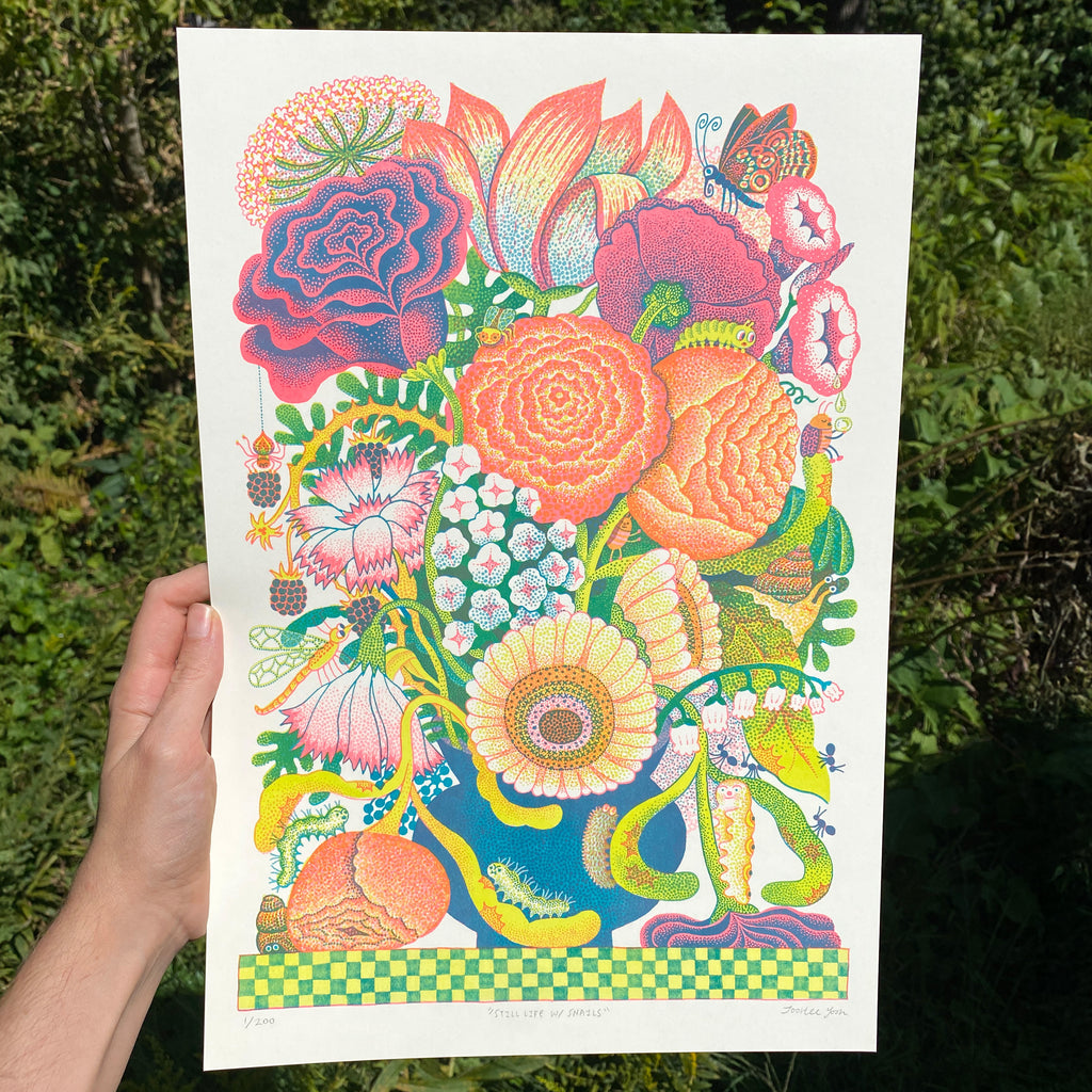 Colorful floral illustration held in front of a natural background